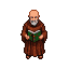 Elderly monk in brown robe and cowl, top-down view, reading an open book.