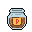 A glass jar with a blue lid, filled with murky brown liquid and red flecks. A golden label on the jar has a red letter "P."