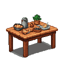 Rustic wooden kitchen table with a spread of food, including a bowl of bread or pastries, a tall shaker, and a small potted plant.