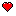 Vibrant red pixel art heart with white highlights on a black background.