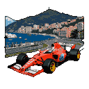 A red Formula 1 car speeds along the Monaco street circuit, with the city's harbor and buildings visible in the background under a bright sky.