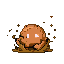 Blob-like creature made of brown and tan pixels squirming in a mud puddle, with white pixel eyes looking forward.