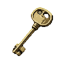 Antique brass key with circular bow openings and a detailed bit, against a black background.