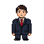 A person in a dark suit and red tie, with neatly styled brown hair.